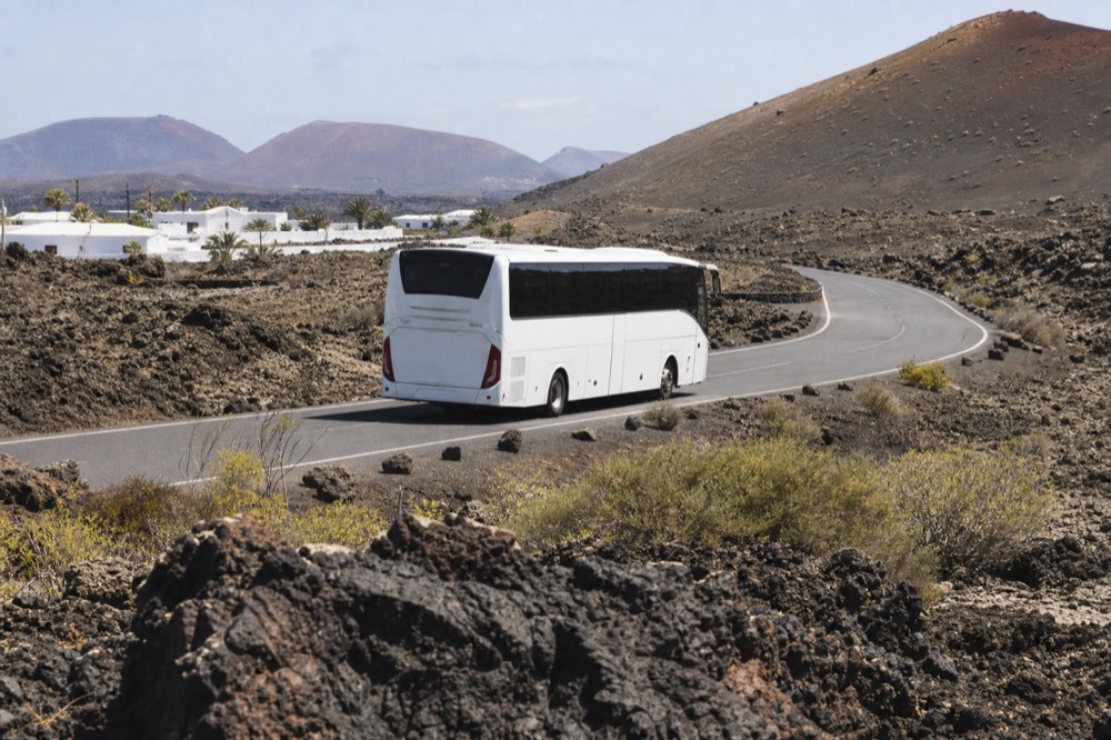 Coach bus on the Ruta de los Volcanes road inside Timanfaya