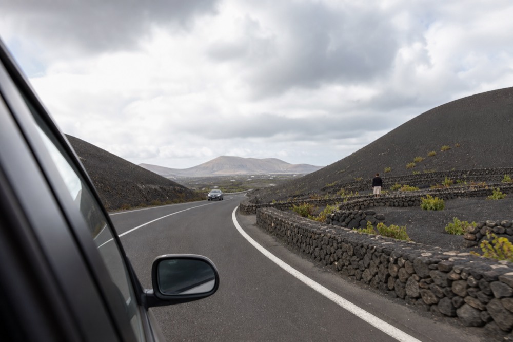 The LZ-30 road winding between volcanic ash vine pits in La Geria